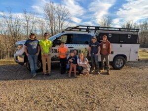 Group of solar workers standing by truck